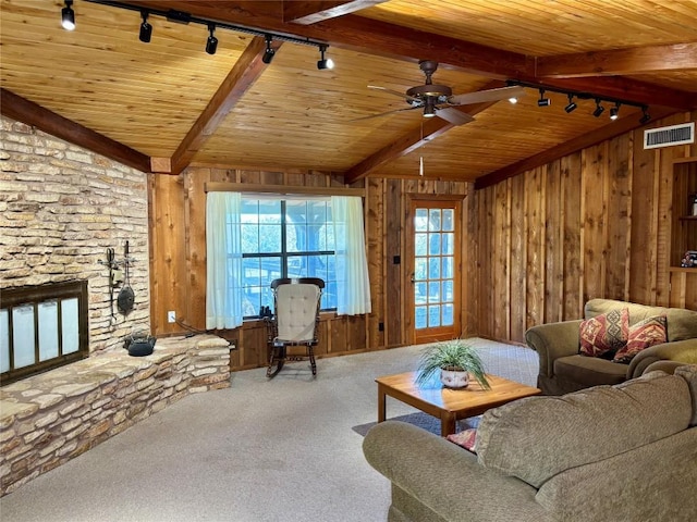 living area featuring rail lighting, carpet floors, a wealth of natural light, visible vents, and wooden ceiling