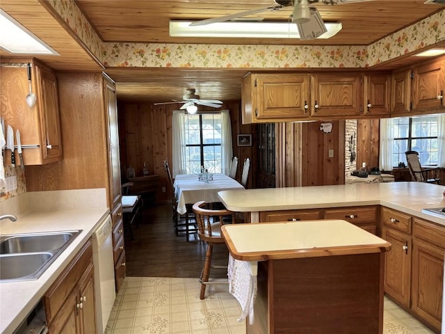 kitchen featuring a sink, light countertops, ceiling fan, and white dishwasher