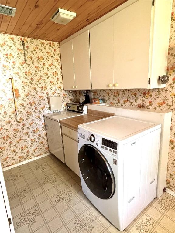 laundry area featuring washer / clothes dryer, wallpapered walls, and light floors