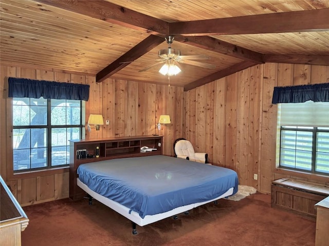carpeted bedroom featuring wood walls, ceiling fan, vaulted ceiling with beams, and wood ceiling