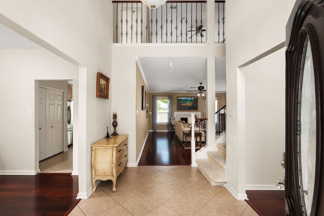 12528 E Labrador Cv, Austin, TX 78729 - tiled foyer entrance with a ceiling fan, stairs, and a towering ceiling