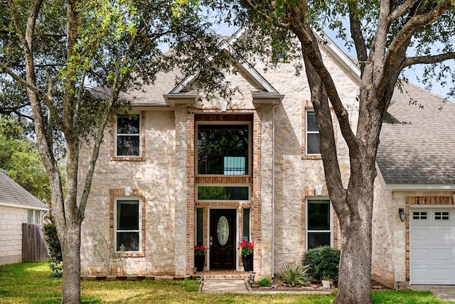 12528 E Labrador Cv, Austin, TX 78729 - view of front of house featuring a shingled roof, an attached garage, and a front yard