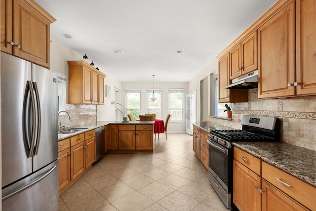 12528 E Labrador Cv, Austin, TX 78729 - kitchen featuring stainless steel appliances, under cabinet range hood, a peninsula, backsplash, and light tile patterned floors