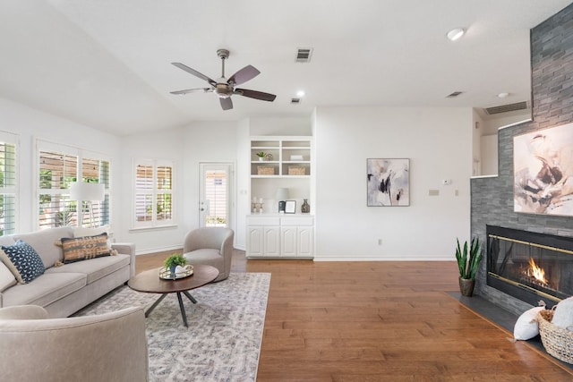 30203 Hacienda Ln, Georgetown, TX 78628 - living area featuring a fireplace, wood finished floors, ceiling fan, and lofted ceiling