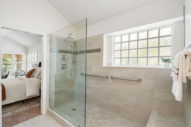 30203 Hacienda Ln, Georgetown, TX 78628 - ensuite bathroom featuring vaulted ceiling, a walk in shower, and tile patterned flooring
