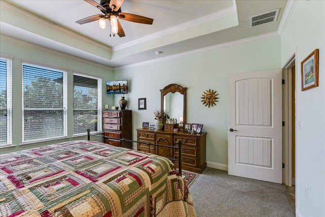 603 Archer Ln, Georgetown, TX 78633 - carpeted bedroom with crown molding, visible vents, baseboards, and a raised ceiling