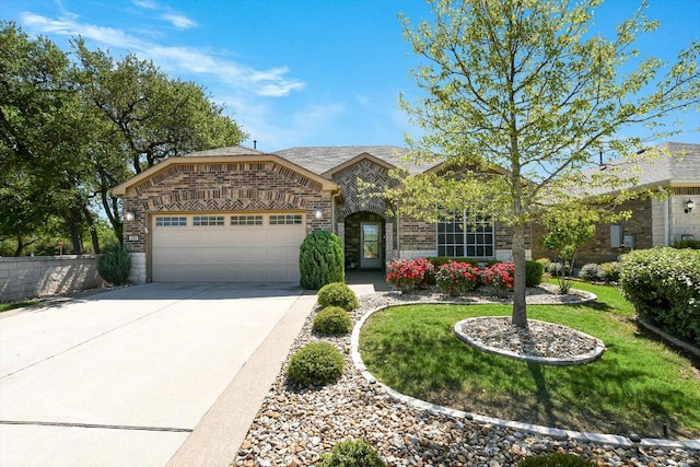 603 Archer Ln, Georgetown, TX 78633 - view of front of home featuring driveway, stone siding, an attached garage, a front yard, and brick siding