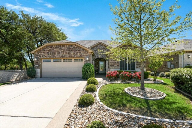 603 Archer Ln, Georgetown, TX 78633 - french provincial home with a garage, driveway, stone siding, brick siding, and a front lawn