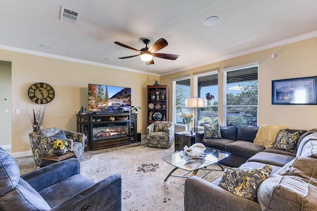 603 Archer Ln, Georgetown, TX 78633 - living area featuring crown molding, visible vents, ceiling fan, and a glass covered fireplace