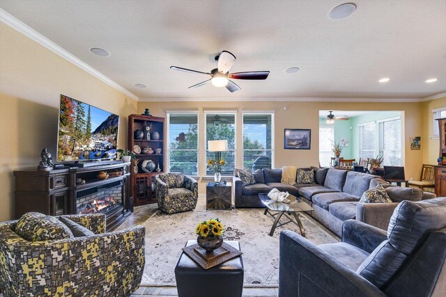 603 Archer Ln, Georgetown, TX 78633 - living room with ceiling fan, crown molding, recessed lighting, wood finished floors, and a lit fireplace