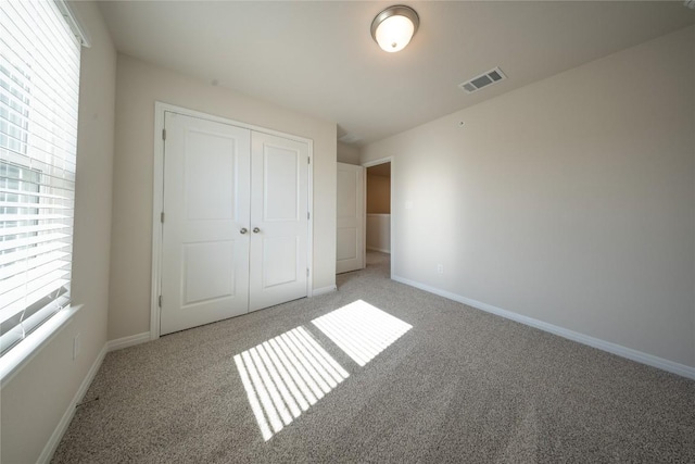 1850 Settlers Glen Dr Unit 904, Round Rock, TX 78665 - unfurnished bedroom featuring visible vents, baseboards, a closet, and light carpet