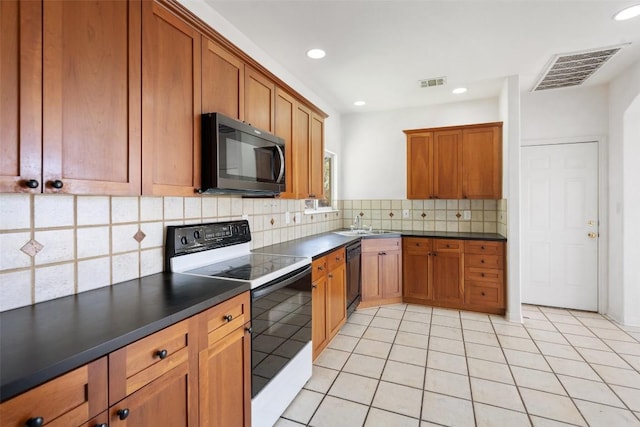 403 Rogart Dr, Spicewood, TX 78669 - kitchen featuring dark countertops, visible vents, brown cabinets, and white electric range oven