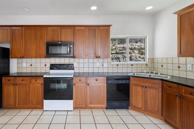 403 Rogart Dr, Spicewood, TX 78669 - kitchen with black appliances, a sink, brown cabinets, and dark countertops