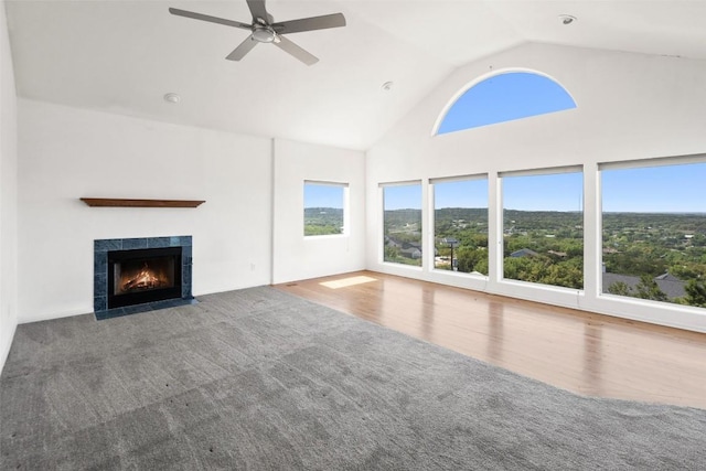 403 Rogart Dr, Spicewood, TX 78669 - unfurnished living room featuring a fireplace, carpet, ceiling fan, and high vaulted ceiling