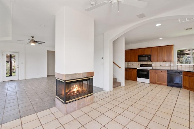 403 Rogart Dr, Spicewood, TX 78669 - kitchen featuring black appliances, a ceiling fan, brown cabinetry, tasteful backsplash, and light tile patterned floors