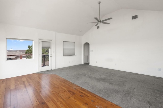 403 Rogart Dr, Spicewood, TX 78669 - unfurnished living room with visible vents, arched walkways, a ceiling fan, and carpet