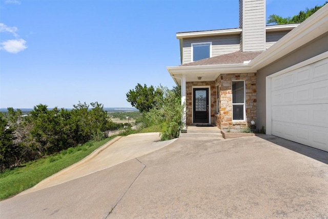 403 Rogart Dr, Spicewood, TX 78669 - doorway to property featuring a chimney, aphalt driveway, an attached garage, and stone siding