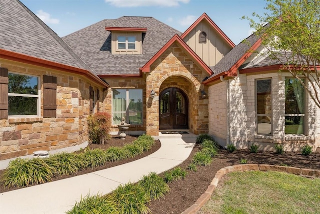 617 Chama Trce, Dripping Springs, TX 78620 - doorway to property featuring stone siding, roof with shingles, french doors, and board and batten siding