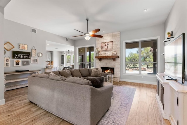 617 Chama Trce, Dripping Springs, TX 78620 - living room with a ceiling fan, light wood-style floors, a stone fireplace, baseboards, and recessed lighting
