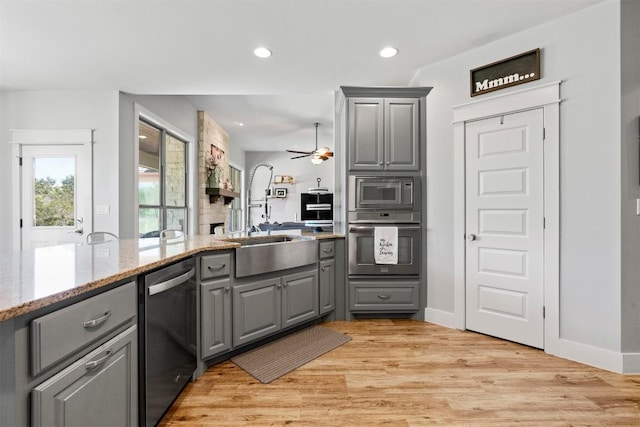 617 Chama Trce, Dripping Springs, TX 78620 - kitchen featuring gray cabinets, stainless steel appliances, ceiling fan, recessed lighting, and light stone counters