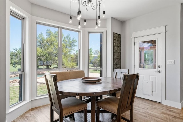 617 Chama Trce, Dripping Springs, TX 78620 - dining room with plenty of natural light, light wood-style flooring, and a chandelier