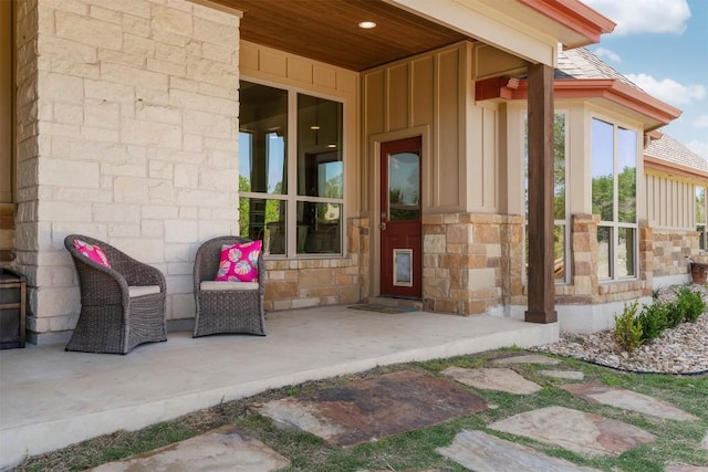 617 Chama Trce, Dripping Springs, TX 78620 - doorway to property with board and batten siding and stone siding