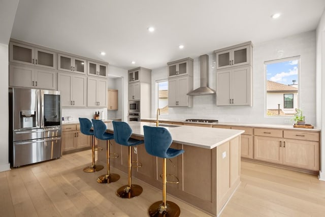 6701 Adventures Pl, Jonestown, TX 78645 - kitchen featuring wall chimney range hood, stainless steel appliances, a healthy amount of sunlight, and a sink