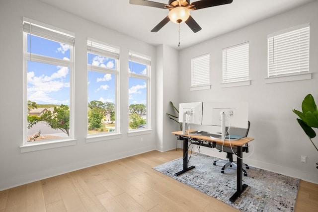 6701 Adventures Pl, Jonestown, TX 78645 - office with wood finished floors, a ceiling fan, and a healthy amount of sunlight