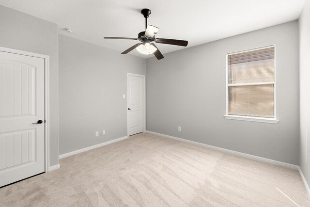 unfurnished bedroom featuring a ceiling fan, baseboards, and carpet