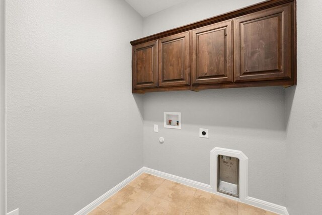 laundry area featuring cabinet space, washer hookup, gas dryer hookup, baseboards, and electric dryer hookup