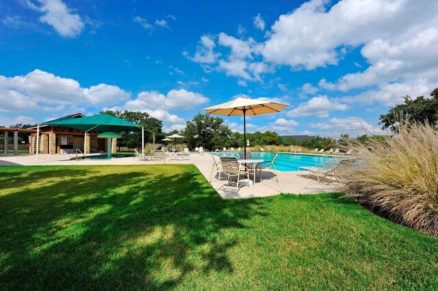 community pool with a yard and a patio