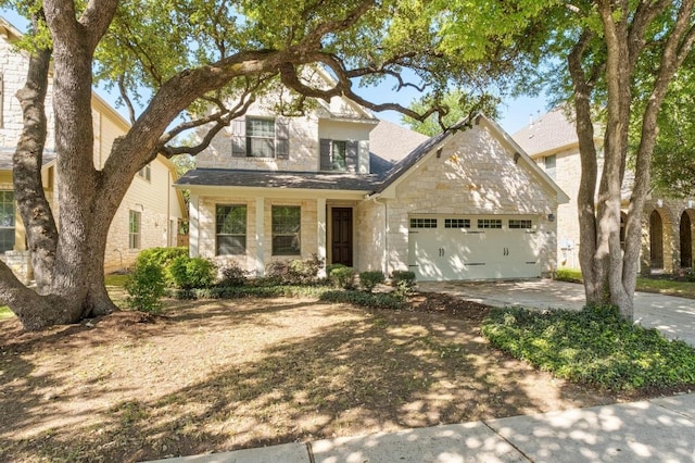 traditional home featuring a garage, concrete driveway, and stone siding