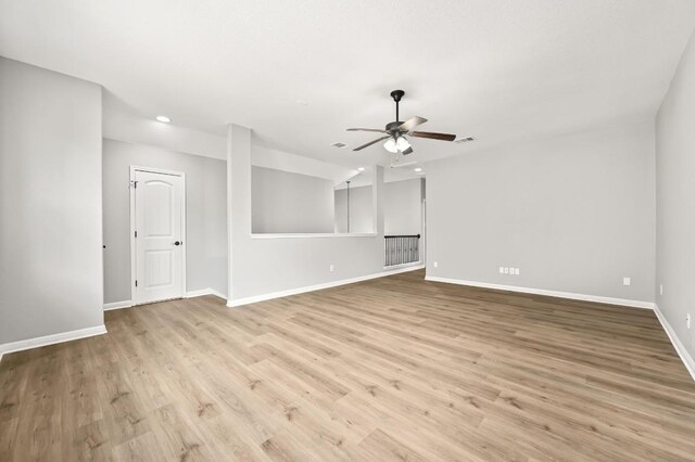 unfurnished living room with ceiling fan, visible vents, wood finished floors, baseboards, and recessed lighting