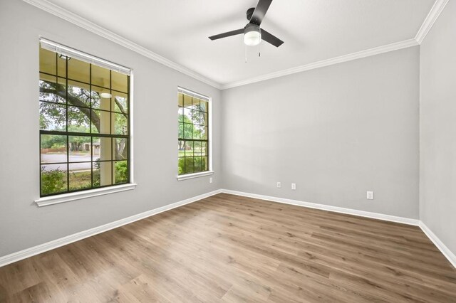 empty room featuring crown molding, a ceiling fan, baseboards, and wood finished floors
