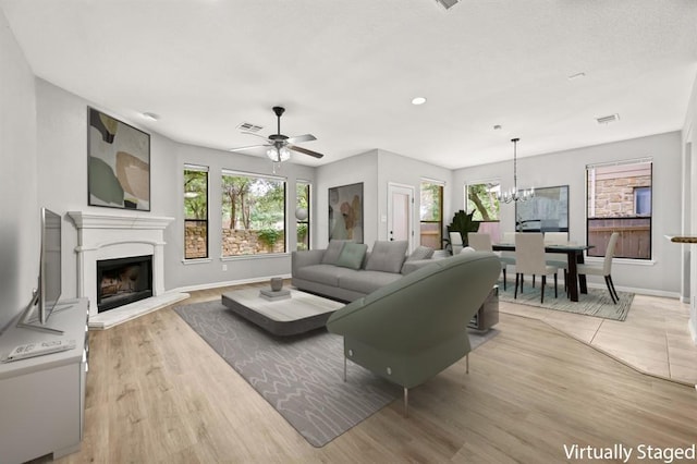 4014 Remington Rd, Cedar Park, TX 78613 - living area featuring plenty of natural light, a fireplace with raised hearth, ceiling fan, and baseboards