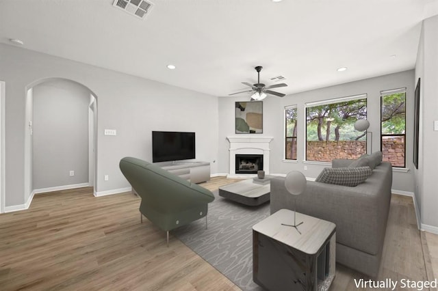 4014 Remington Rd, Cedar Park, TX 78613 - living area featuring a ceiling fan, arched walkways, wood finished floors, a fireplace, and recessed lighting