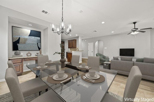 4014 Remington Rd, Cedar Park, TX 78613 - dining space featuring recessed lighting, arched walkways, ceiling fan, baseboards, and a chandelier