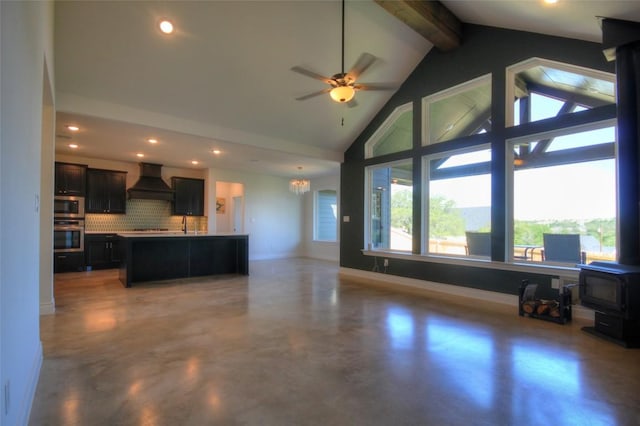 283 Calle Cortez Dr, Buchanan Dam, TX 78609 - living area with recessed lighting, a wood stove, ceiling fan with notable chandelier, and beamed ceiling