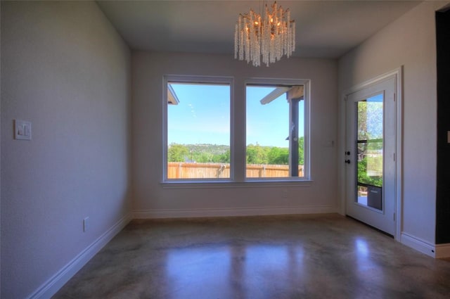 283 Calle Cortez Dr, Buchanan Dam, TX 78609 - unfurnished dining area featuring a chandelier, finished concrete flooring, and baseboards