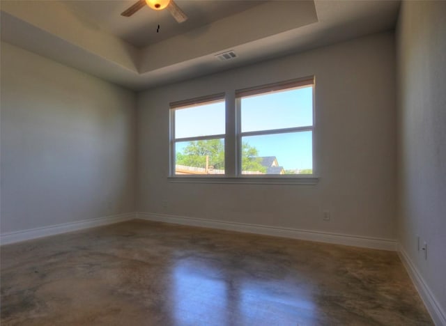 283 Calle Cortez Dr, Buchanan Dam, TX 78609 - empty room with a tray ceiling, concrete floors, a ceiling fan, visible vents, and baseboards