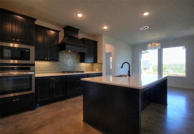 283 Calle Cortez Dr, Buchanan Dam, TX 78609 - kitchen with tasteful backsplash, premium range hood, visible vents, stainless steel appliances, and a sink