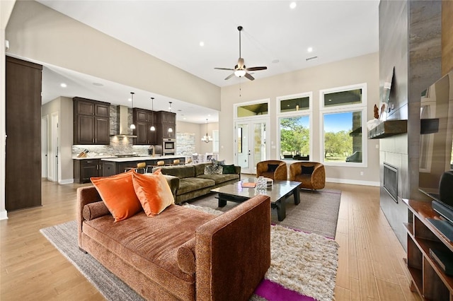 607 Flint Ridge Trl, Georgetown, TX 78628 - living area with a large fireplace, light wood-style floors, a ceiling fan, and recessed lighting