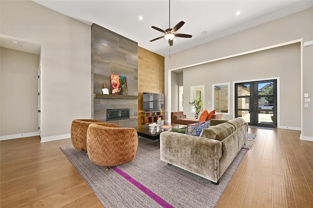607 Flint Ridge Trl, Georgetown, TX 78628 - living room with hardwood / wood-style flooring, ceiling fan, a tiled fireplace, and recessed lighting