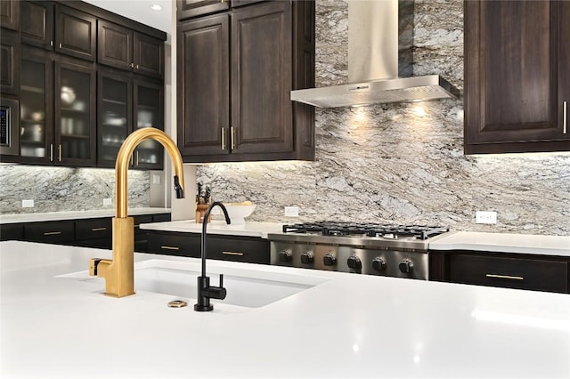 607 Flint Ridge Trl, Georgetown, TX 78628 - kitchen with light countertops, decorative backsplash, wall chimney exhaust hood, and dark brown cabinetry