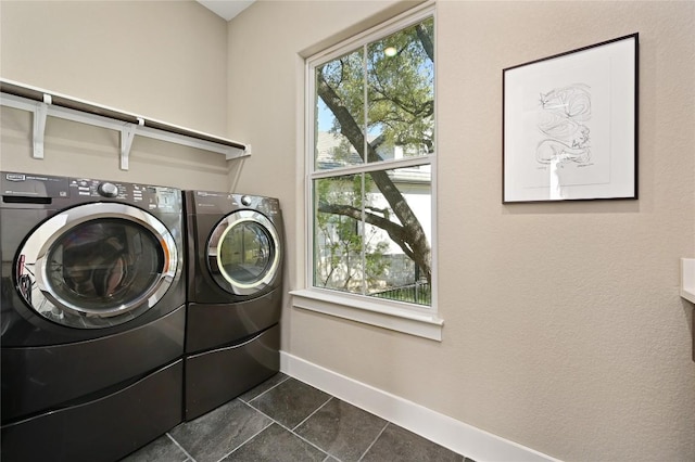 607 Flint Ridge Trl, Georgetown, TX 78628 - laundry area with dark tile patterned flooring, independent washer and dryer, laundry area, and baseboards