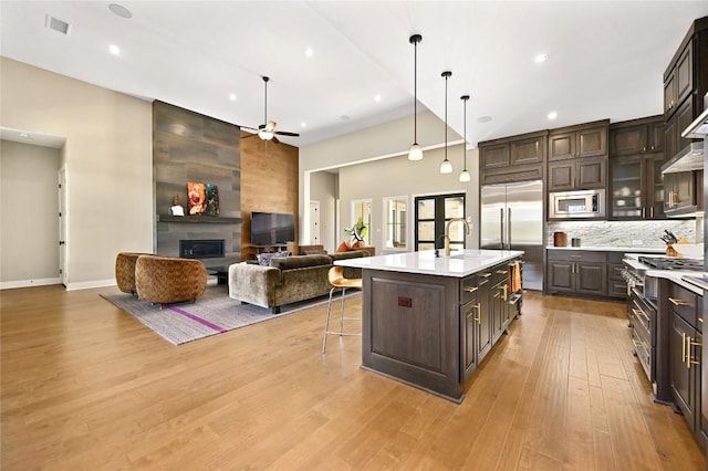 607 Flint Ridge Trl, Georgetown, TX 78628 - kitchen featuring built in appliances, light countertops, dark brown cabinets, ceiling fan, and a sink