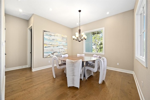 607 Flint Ridge Trl, Georgetown, TX 78628 - dining area featuring wood finished floors, a notable chandelier, and baseboards