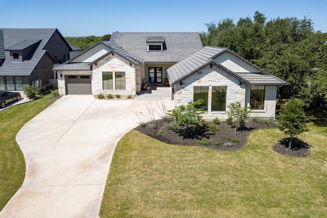 607 Flint Ridge Trl, Georgetown, TX 78628 - modern farmhouse with french doors, a front lawn, stone siding, concrete driveway, and an attached garage