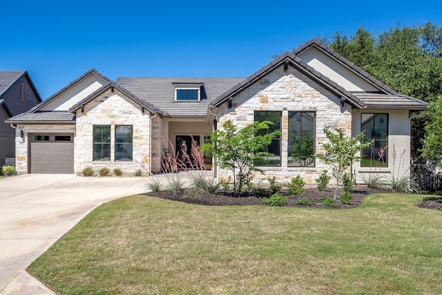 607 Flint Ridge Trl, Georgetown, TX 78628 - craftsman inspired home featuring a tile roof, driveway, stone siding, an attached garage, and a front yard