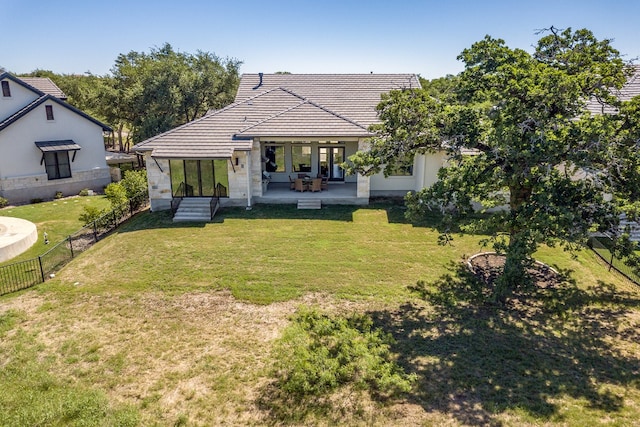 607 Flint Ridge Trl, Georgetown, TX 78628 - back of property with fence, a tile roof, french doors, a patio, and a lawn